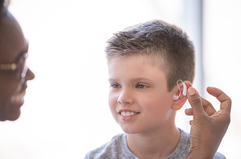 young-boy-wearing-a-hearing-aid-1024x675.jpg